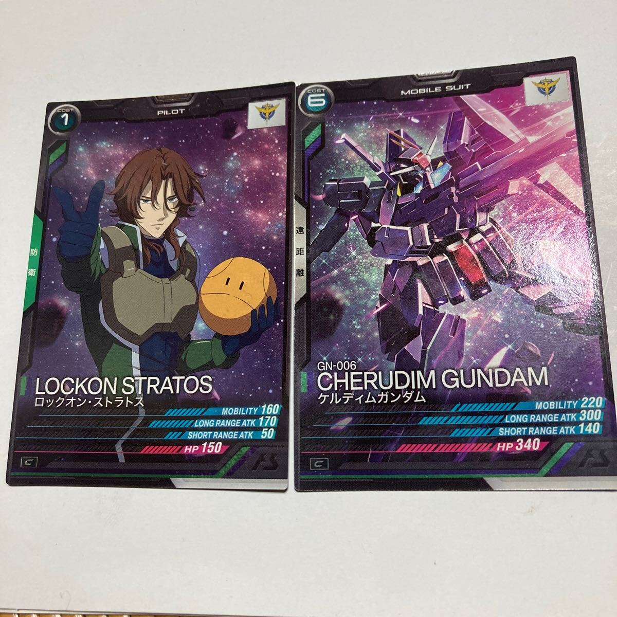 機動戦士ガンダム アーセナルベース ケルディムガンダム ロックオン?ストラトス 2枚セット