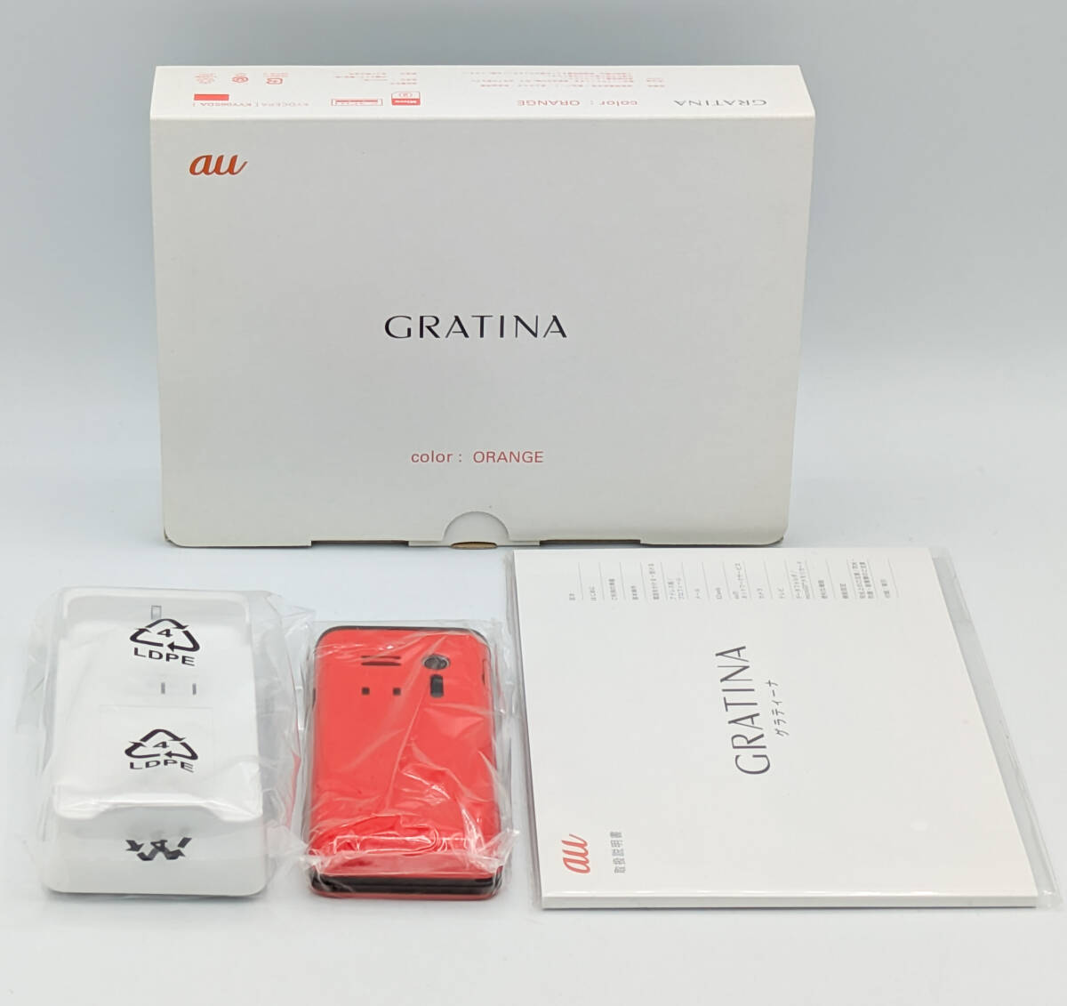 【未使用近】au GRATINA KYY06SDA(オレンジ) 箱・説明書・卓上ホルダ付 ●3G・携帯・ガラケー●京セラ製●グラティーナ●残債無●初期化済