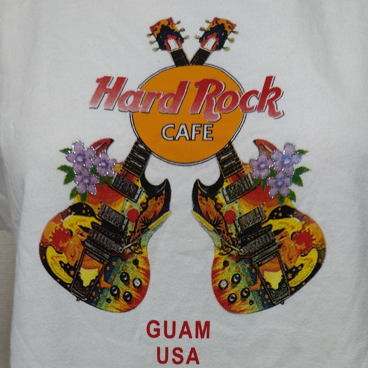 ハードロックカフェ半袖TシャツM　白「GUAM」ツインギターにラメがきれいなお花プリント♪　可愛い！　Hard Rock Cafe