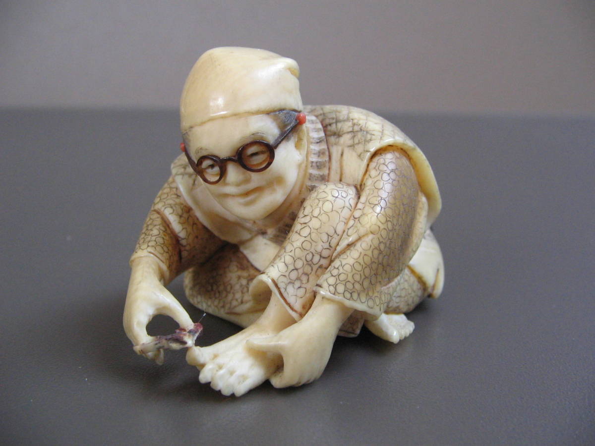  netsuke block person image nail clippers inspection ). thing old fine art sculpture old house place warehouse 