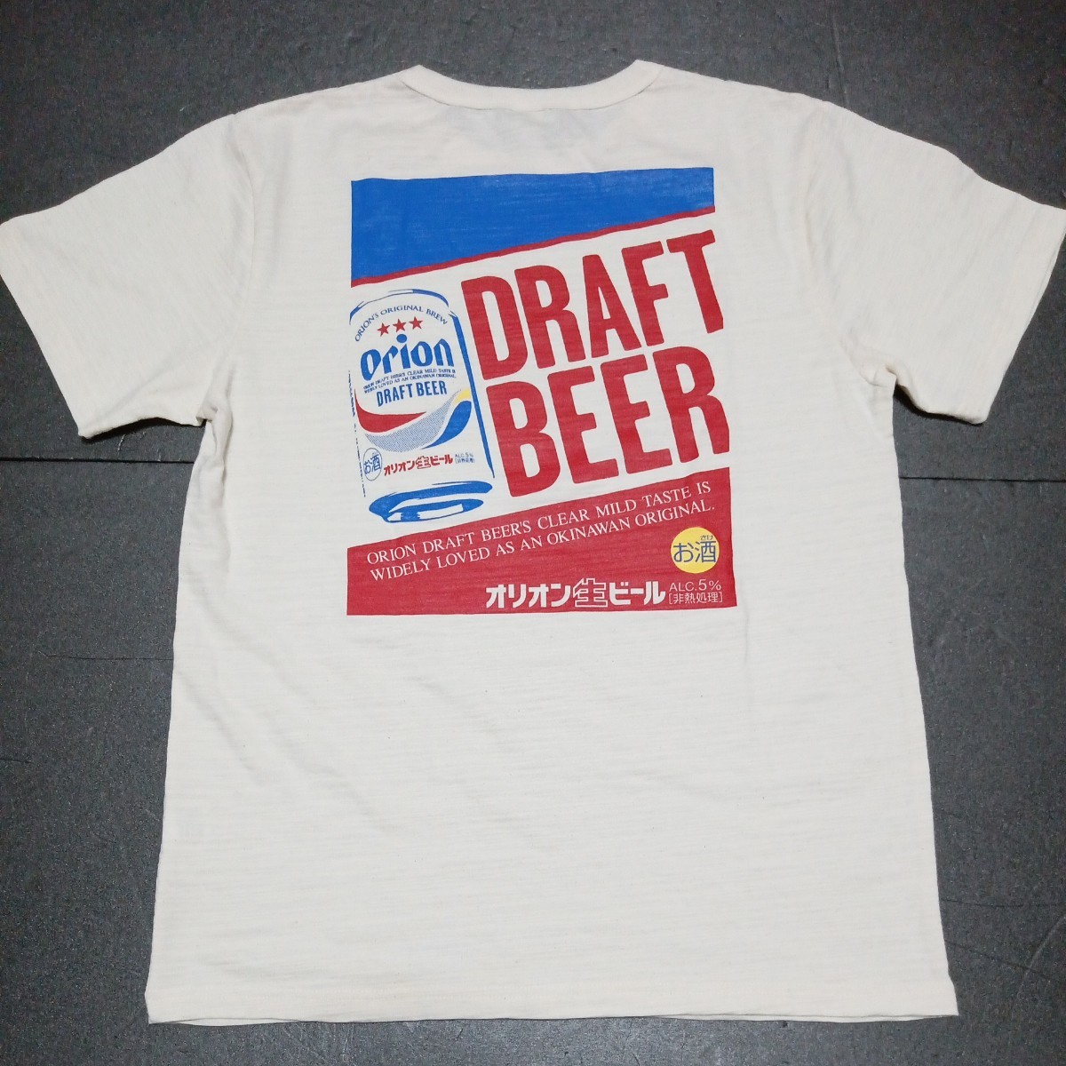 ● オリオンビール「Orion Tシャツ 1枚」着丈：約64cm／身幅：約49cm　半袖 表記サイズM　シャツ　アイボリー系　缶ビール柄