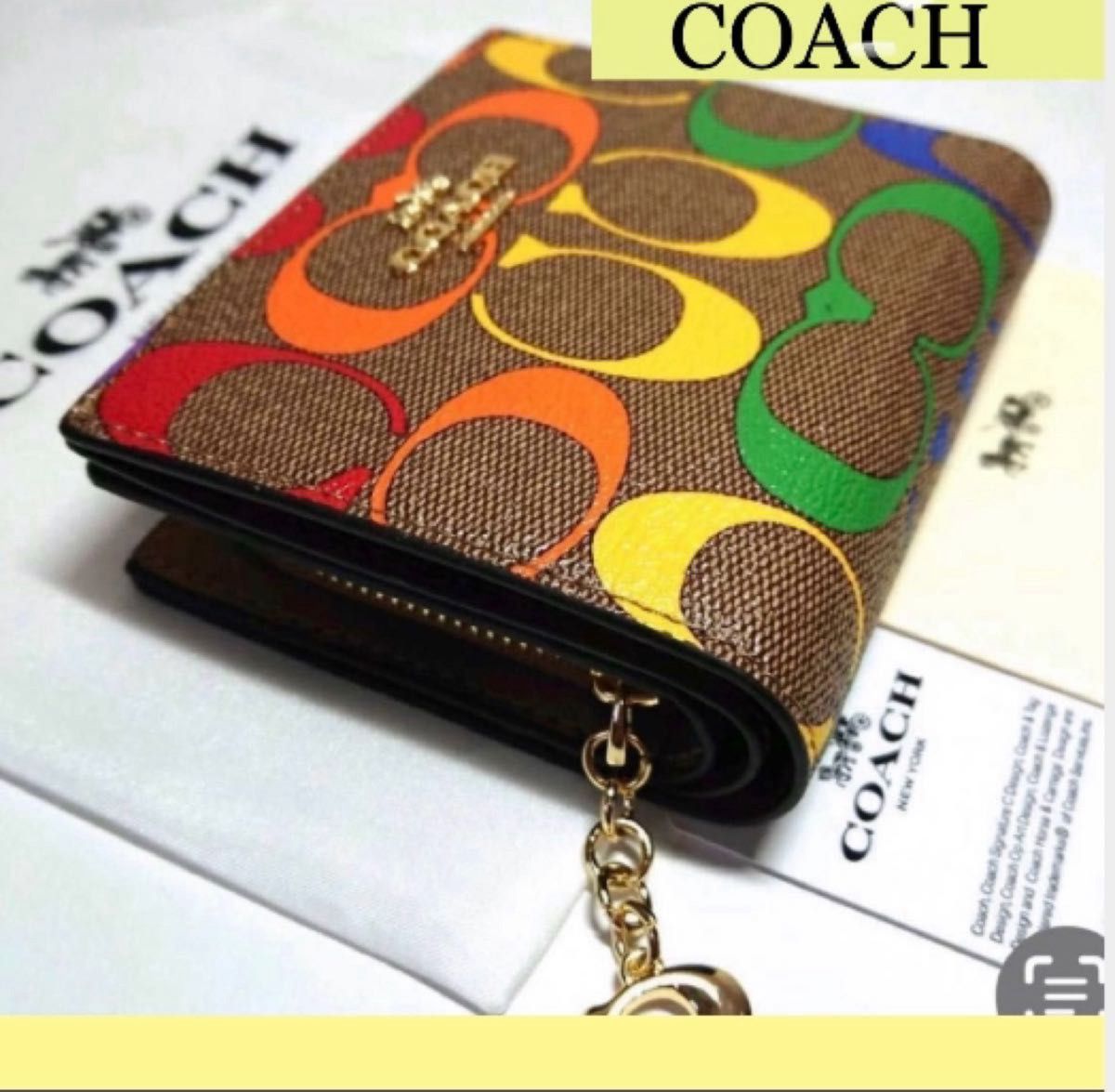 新品未使用】COACHコーチ 二つ折り財布 レインボーシグネチャー-