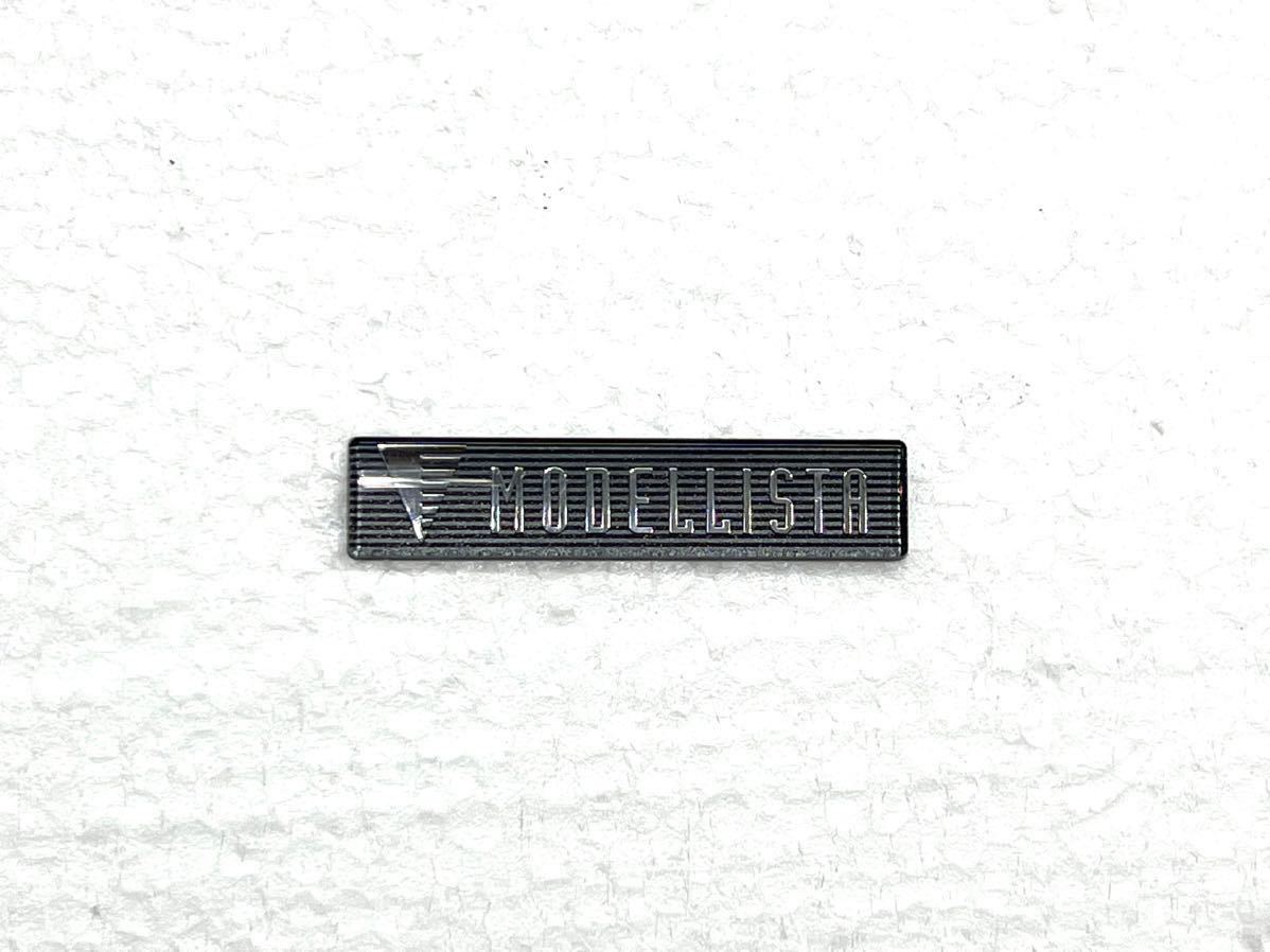 トヨタモデリスタ MODELLISTA エンブレム プレート 5.5cm×1.2cm フロントスポイラー ①_画像1