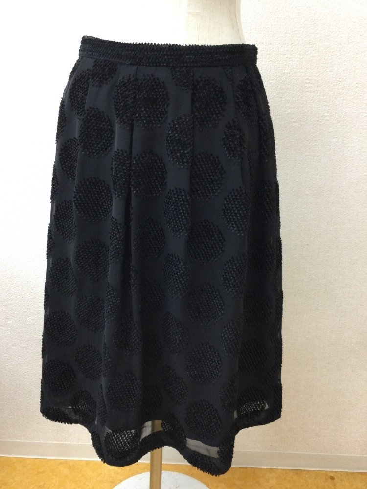 K.T. Kiyoko takase black. knees height skirt flocky manner. Circle pattern 