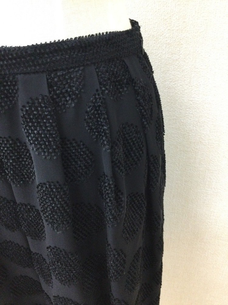 K.T. Kiyoko takase black. knees height skirt flocky manner. Circle pattern 