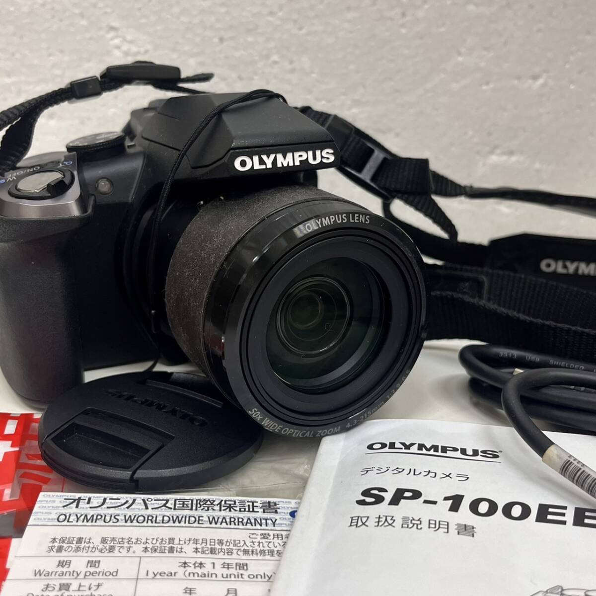 【C-23940】オリンパス OLYMPUS STYLUS SP-100EEコンパクトデジタルカメラ 通電確認済み 付属完品 中古_画像1