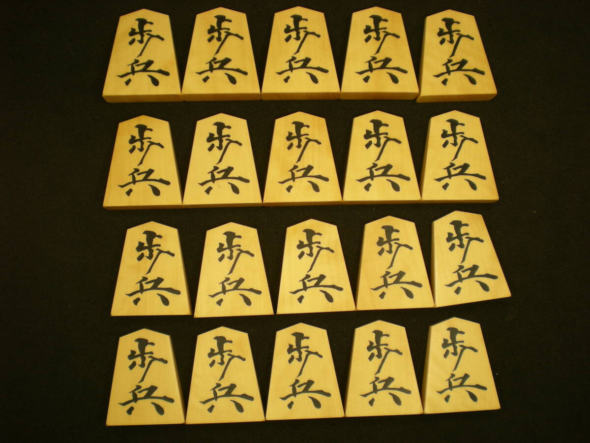  shogi carving . piece island yellow .. entering . eyes empty .