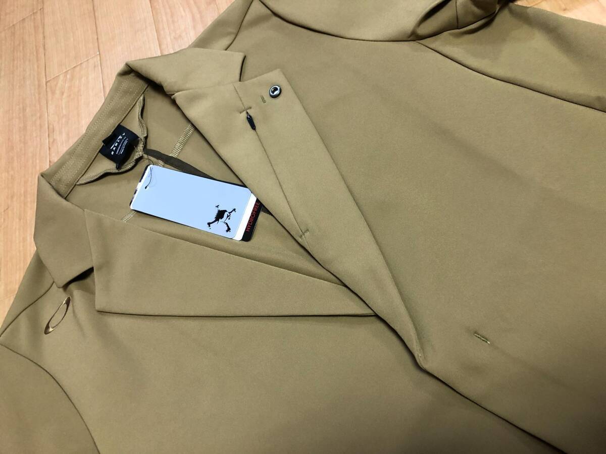 OAKLEY GOLF(オークリーゴルフ)SKULL COMMON TAILORED JACKET 4.0 撥水,4way Stretch,UPF50+ ジャケット FOA404131(ANTIQUE BRONZE)Ｌの画像1