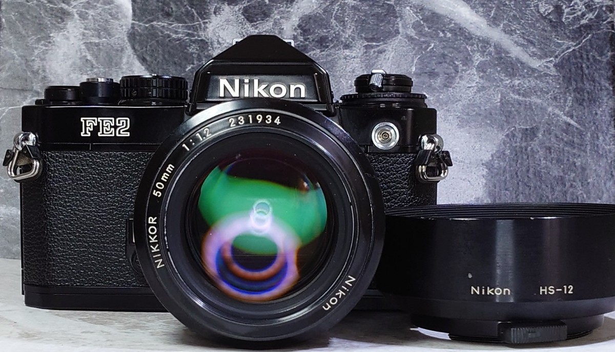 【終活コレクション整理】 Nikon FE2黒＋Ai NIKKOR 50mm f1.2 シンデレラ単焦点 純正メタルフード付 各動作良好 露出計メーターOK 光学美品_画像1