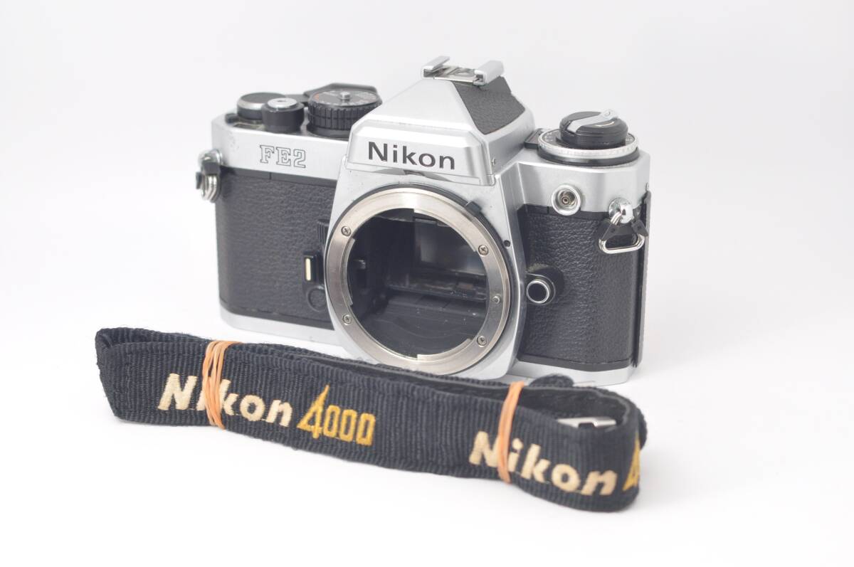 ★ジャンク★ ニコン Nikon FE2 + 4000 New FM2 発売記念 ストラップ L1354＃G1151_画像1