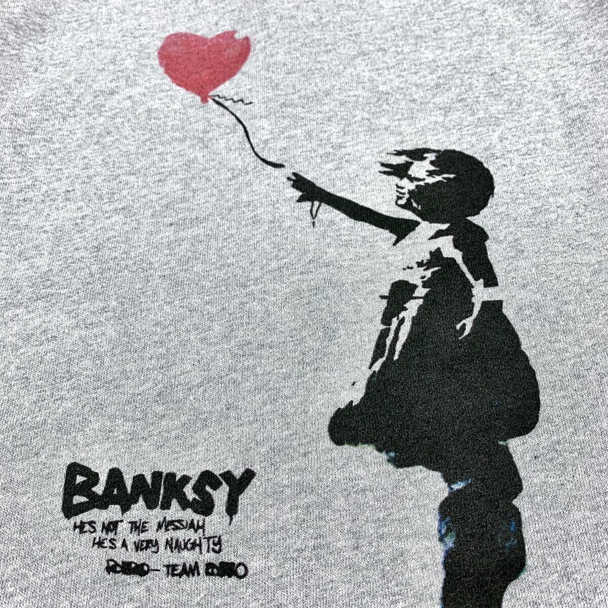 新品 BANKSY バンクシー 愛はごみ箱の中に 風船と少女 シュレッダー 左向き バックプリント ジップアップ パーカー ユニセックス Mサイズ