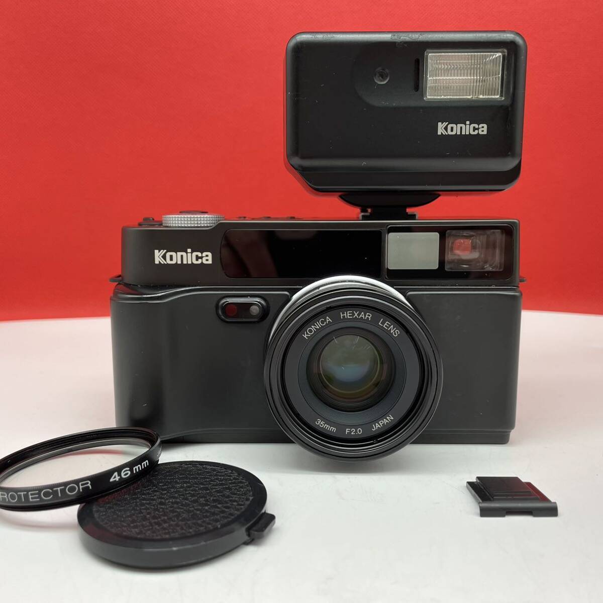 □ KONICA HEXAR black コンパクトフィルムカメラ 35mm F2.0 動作確認済 シャッター、露出計OK ストロボ コニカの画像1