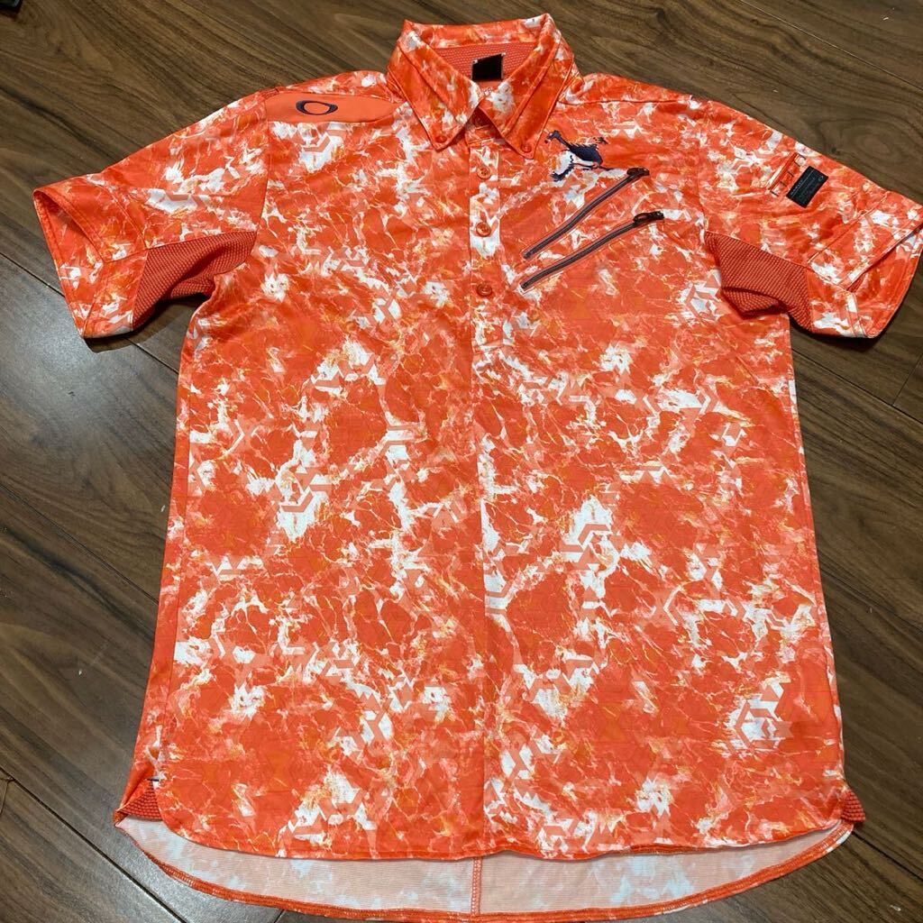 美品 OAKLEY オークリー 半袖ゴルフシャツ L メンズゴルフウェア スカル刺繍 吸汗速乾 ストレッチ オレンジ系の画像1