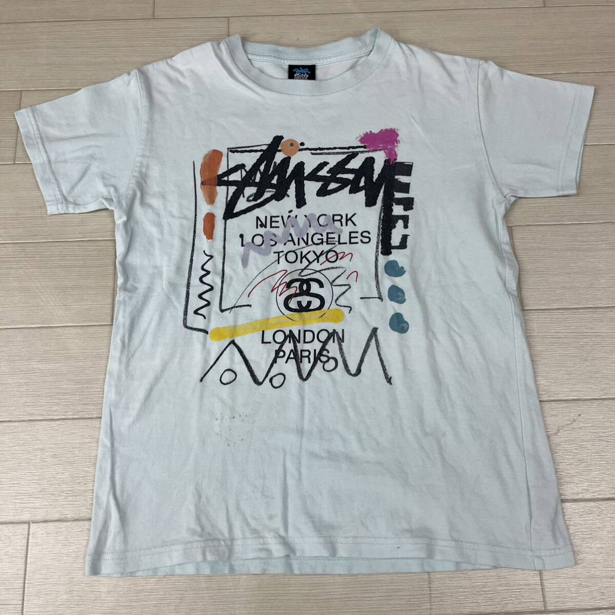 M■ 希少 STUSSY ca28629 World tour ステューシー ワールドツアー キッズ 半袖Tシャツ XL 150サイズ ブルー 水色 ロゴ ペイント柄 