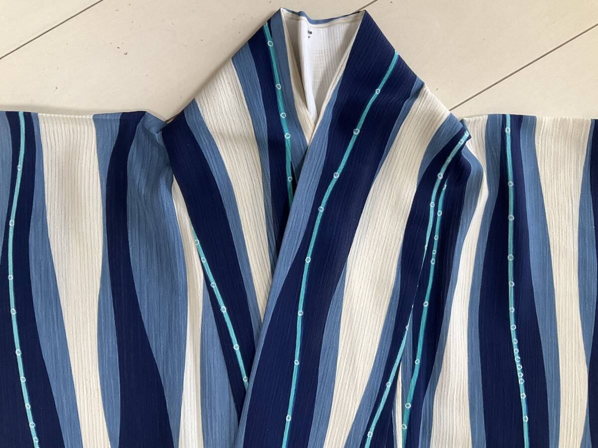 #e2910# used # polyester # unbleached cloth color . dark blue * light flower color ... striped pattern single . kimono # height 162.68#. length 