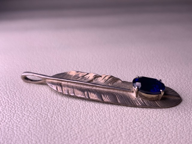 # pendant top feather motif * material . there is no sign / silver color / accessory / details unknown 