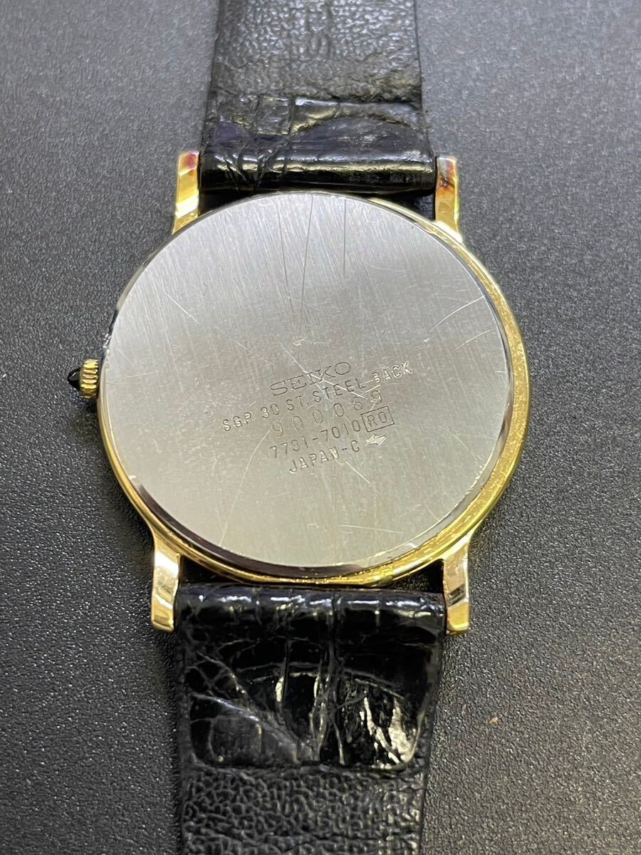 SEIKO Seiko Dolce Dolce 7731-7010 3 hands round Gold face men's quarts battery type wristwatch operation not yet verification reverse side cover coming off Junk 