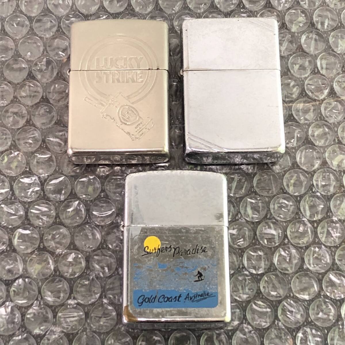 YB100270(053)-101/IR4000【名古屋】Zippo ジッポー 3点まとめ J XⅣ LUCKY STRIKE / Ⅱ PAT. 2032695 / C Ⅵ Gold Coast Australia_画像1