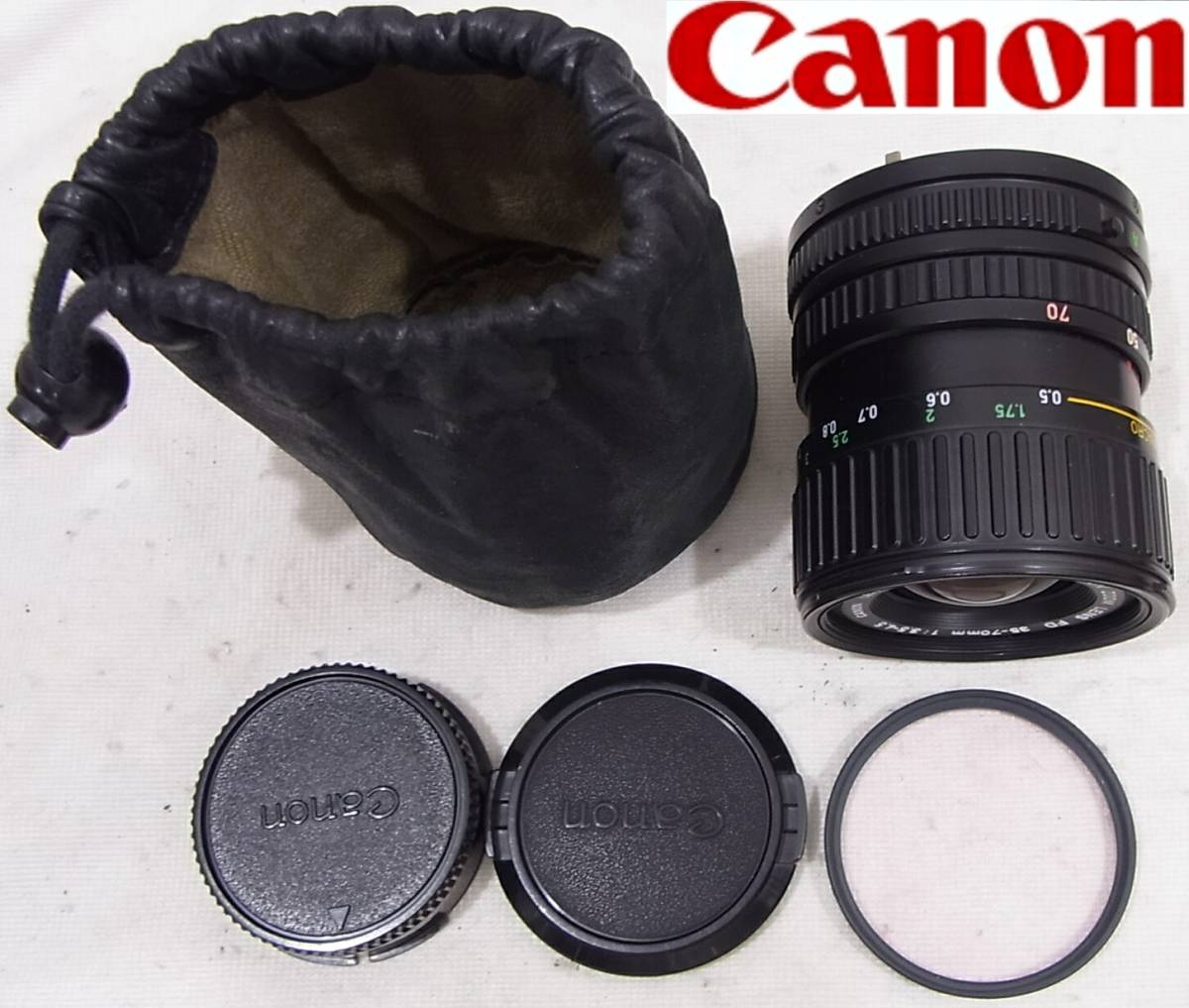 即決は送料無料 キャノンZoom Lens FD 35-70mm f3.5-4.5日本製Canon完動品MADE IN JAPAN レザーポーチ & kenko MC 1Bスカイライト 52mm付き_画像1