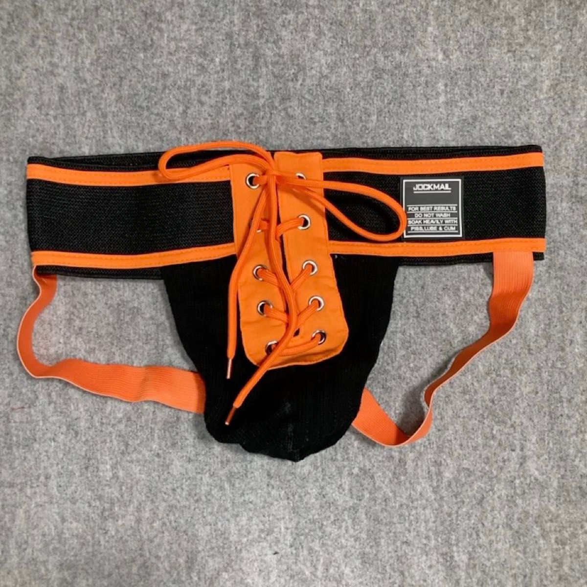 【JOCKMAIL】ジョックストラップ(ケツワレ) オレンジ ブラック 前面開口 紐付き Mサイズ
