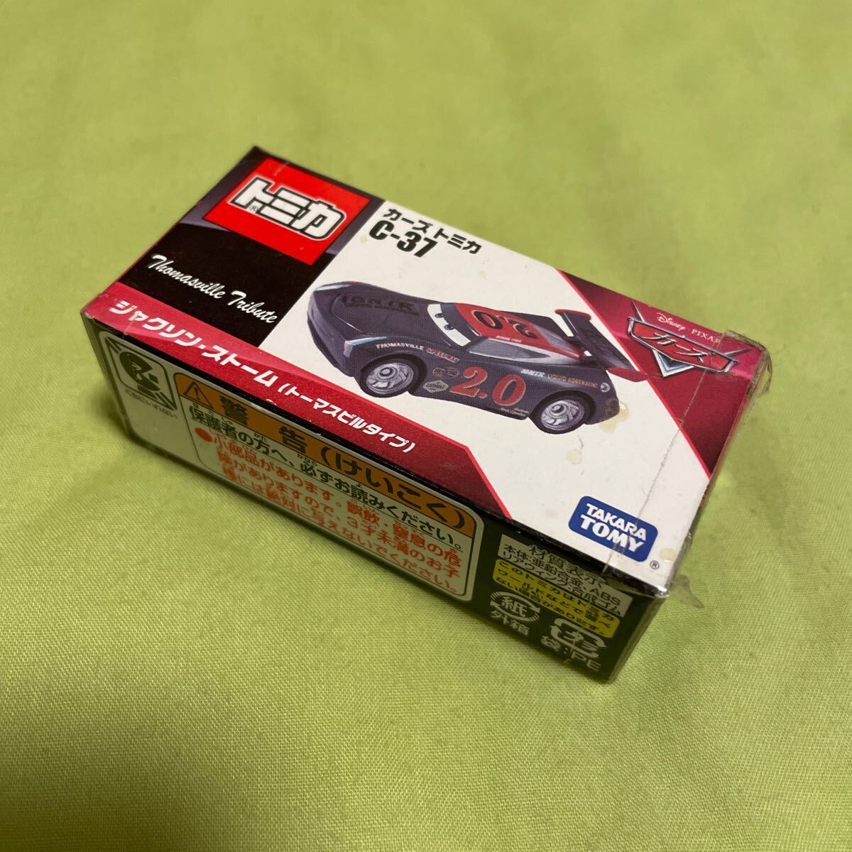 新品未開封　カーズトミカ　C-37 ジャクソンストーム（トーマスビルタイプ）送料込　外箱若干の傷あり　2019年発売品
